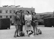 <p>King George VI and Queen Elizabeth with their daughters, Princess Margaret (right) and Princess Elizabeth (left) at the Royal Lodge, Windsor. The family dogs lie sweetly at their feet. </p>