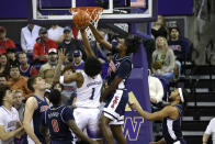 Arizona guard Cedric Henderson Jr., second from right, blocks a shot by Washington forward Keion Brooks (1) during the first half of an NCAA college basketball game, Saturday, Jan. 28, 2023, in Seattle. (AP Photo/John Froschauer)