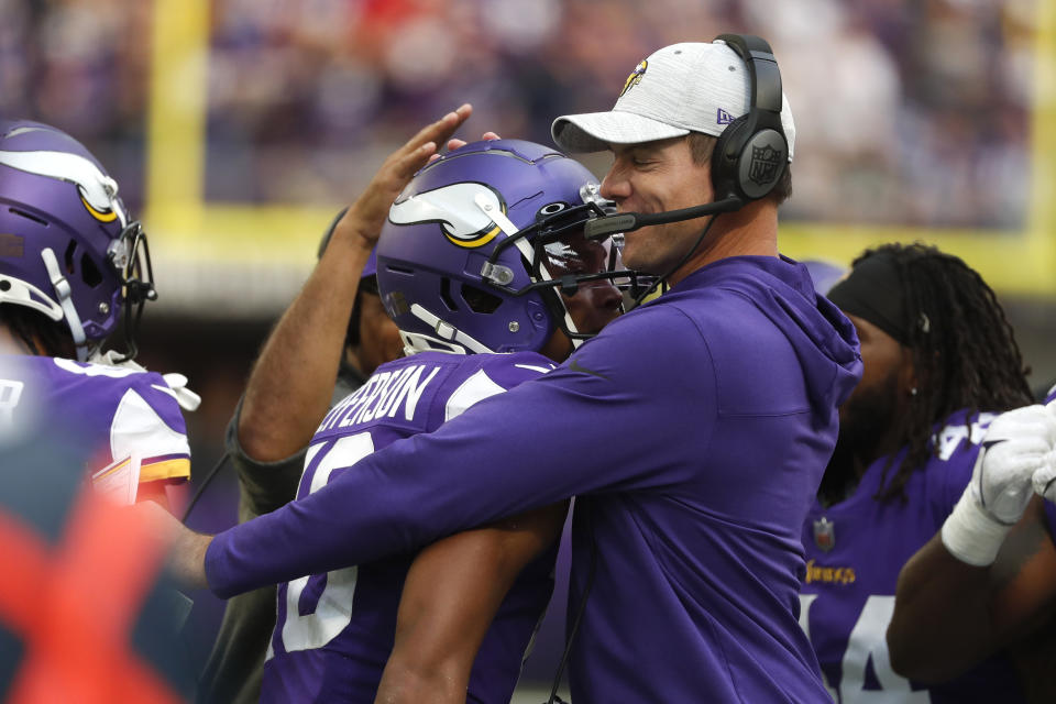 Minnesota Vikings wide receiver Justin Jefferson, left, celebrates with head coach Kevin O'Connell after catching a 36-yard touchdown pass during the first half of an NFL football game against the Green Bay Packers, Sunday, Sept. 11, 2022, in Minneapolis. (AP Photo/Bruce Kluckhohn)