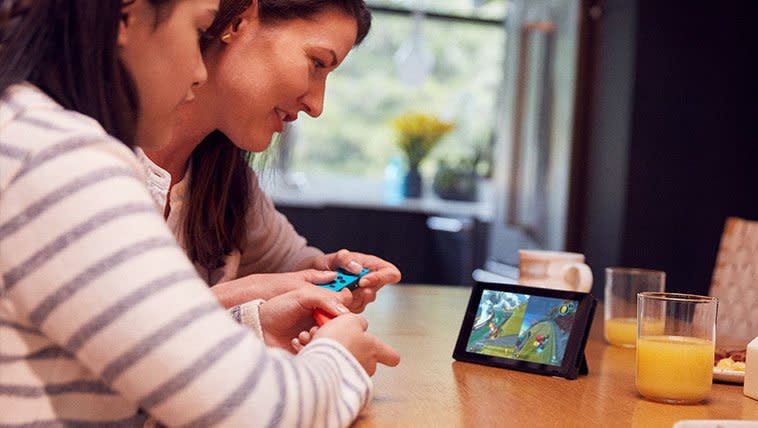 Mother and daughter enjoy a fun Nintendo Switch game together.