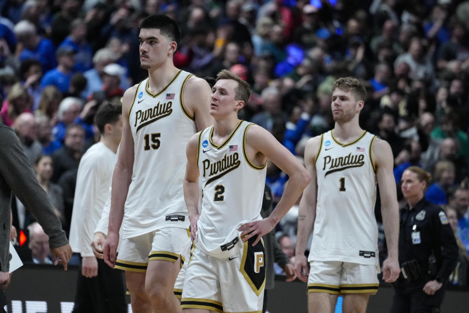 Purdue center Zach Edey (15), guard Fletcher Loyer (2) and forward Caleb Furst (1) walk off the court after loosing to Fairleigh Dickinson 63-58 in a first-round college basketball game in the men's NCAA Tournament in Columbus, Ohio, Friday, March 17, 2023. (AP Photo/Michael Conroy)