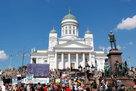 People attend 'Helsinki Calling' protest ahead of meeting between the U.S. President Donald Trump and Russian President Vladimir Putin, in front of Cathedral in Helsinki, Finland July 15, 2018. REUTERS/Leonhard Foeger