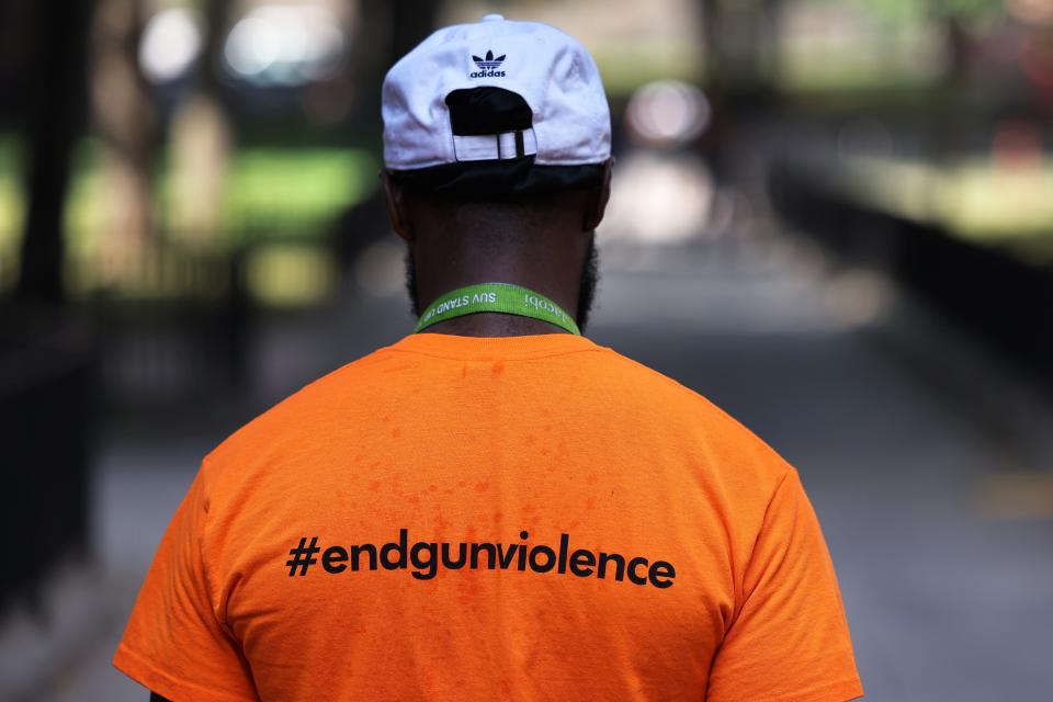 Khayan Reed, an outreach worker with Stand Up to Violence, walks as he and members of Stand Up to Violence canvass and hand out ice cream at the Bronx River Houses on June 30, 2021, in the Soundview neighborhood of Bronx borough in New York City.