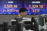 A currency trader watches monitors near the screens showing the Korea Composite Stock Price Index (KOSPI), top left, and the foreign exchange rate between U.S. dollar and South Korean won at the foreign exchange dealing room of the KEB Hana Bank headquarters in Seoul, South Korea, Friday, May 26, 2023. Asian markets were mixed Friday as a deadline loomed for Congress to reach a deal on the U.S. government debt or face a potentially calamitous default. (AP Photo/Ahn Young-joon)