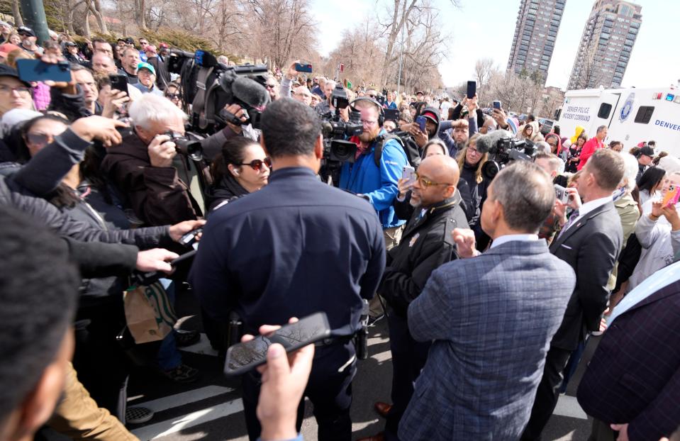 Denver Mayor Michael Hancock, center right, and Chief of Police Ron Thomas, center left, meet with concerned parents as they wait to be reunited with their children following a shooting at East High School, Wednesday, March 22, 2023, in Denver.