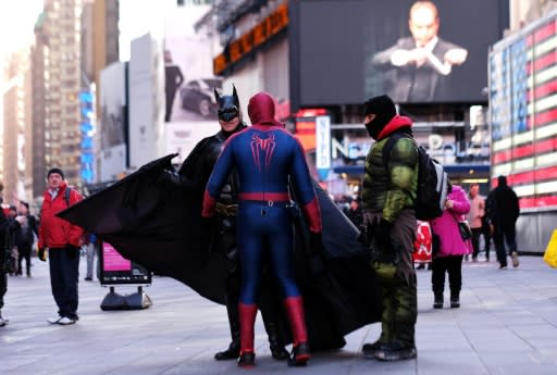 Spider Man, The Hulk and Batman confer at Times Square in New York on February 27, 2015 -- they are among dozens of men and women who earn their livelihood dressing up as cartoon characters and super heroes to pose with tourists for tips