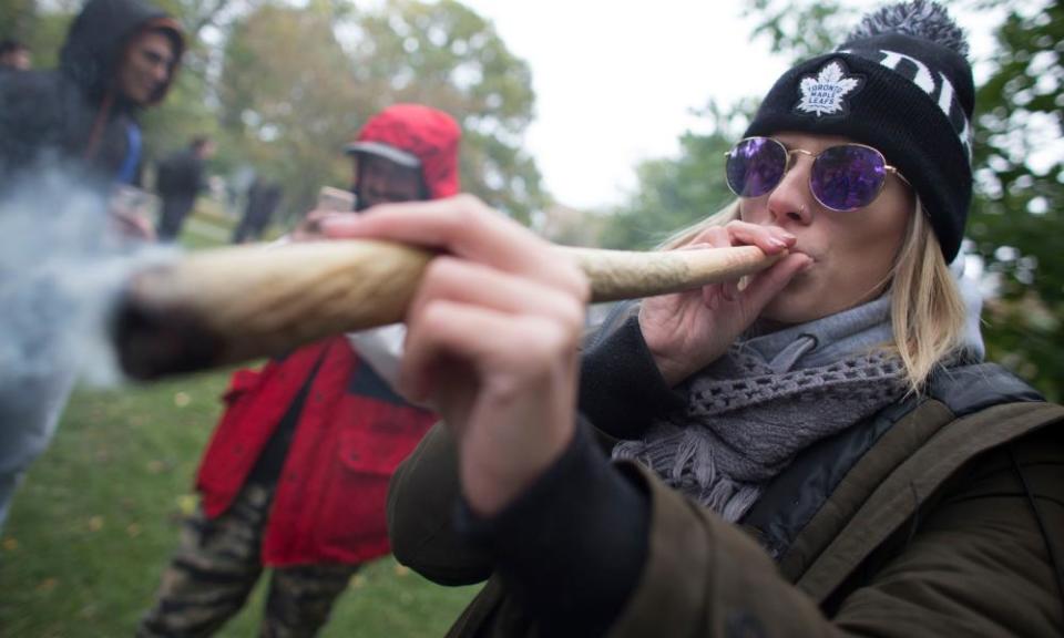 A woman smokes a joint during a legalization party in Toronto, Canada