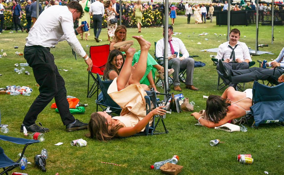 Another racegoer falling off a chair.