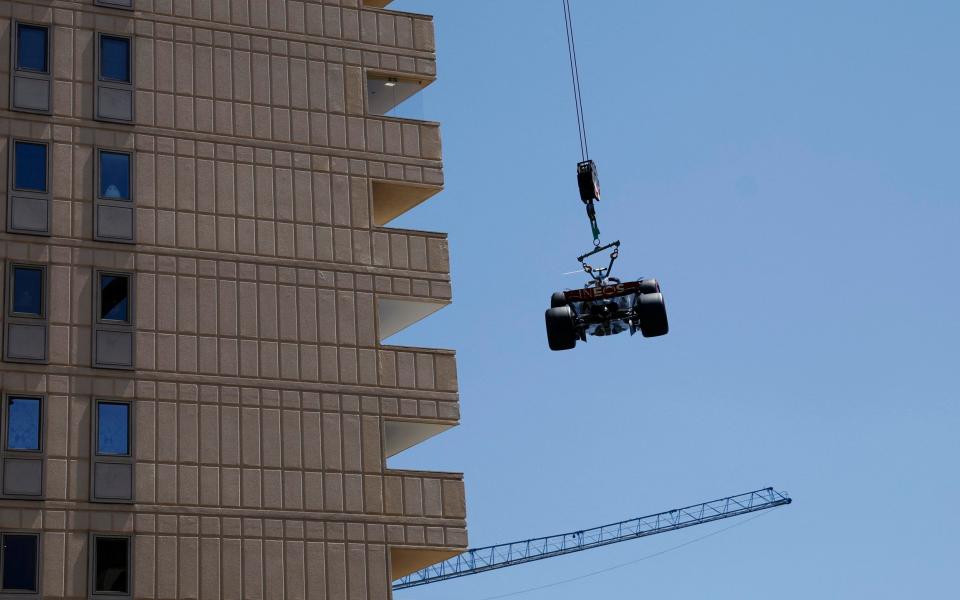 Monaco Grand Prix - Circuit de Monaco, Monte Carlo, Monaco - May 27, 2023 Mercedes' Lewis Hamilton's car is removed from the race track with a crane after crashing during practice - Reuters/Stephane Mahe