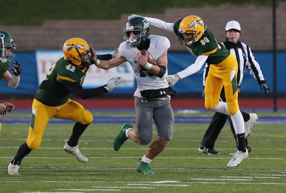 Pleasantville's Daniel Picart (10) looks for some running room in the Ravena defense during the Class B state semifinal at Middletown High School. Pleasantville won the game 15-7.