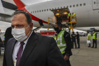 Brazil's Health Minister Eduardo Pazuello arrives to receive a container of vaccines against COVID-19 produced by Oxford/AstraZeneca that arrived from India at the international airport in Sao Paulo, Brazil, Friday, Jan. 22, 2021. (AP Photo/Marcelo Chello)