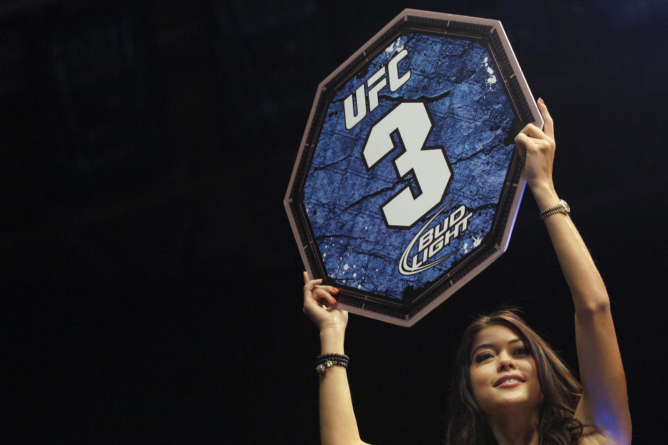 FILE - UFC octagon girl Arianny Celeste holds up a round card during a UFC on Fuel 4 Mixed Martial Arts bout in San Jose, Calif., Wednesday, July 11, 2012. Bud Light is set to return as the official beer of UFC in the U.S. next year. Under a new multi-year marketing deal between UFC and Bud Light maker Anheuser-Busch, the brewer will become the mixed martial arts organization's “Official Beer Partner” in the U.S. starting Jan. 1, per a joint announcement on Tuesday, Oct. 24, 2023. (AP Photo/Jeff Chiu, File)