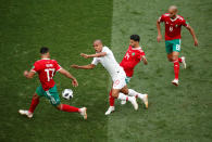 <p>Portugal’s Joao Mario is stopped by Nabil Dirar, Mbark Boussoufa and Karim El Ahmadi </p>