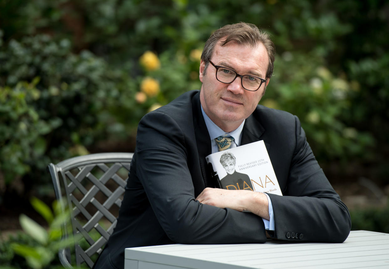 Author Andrew Morton poses with a copy of his book, 