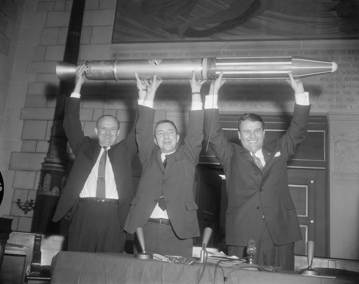 (Original Caption) Washington DC: 2/1/1958- Scientists who participated in the program celebrate the successful launching of the first U.S. satellite at the National Academy of Science. They hold a model of the satellite called 