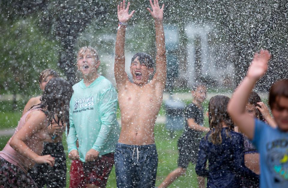 Robert Robinson celebrates the end of the school year with his friends at Jefferson Park in Fort Myers on Thursday, June 17, 2021. The Fort Myers Fire Department brought out their fire hoses to cool off the kids and help them celebrate. 