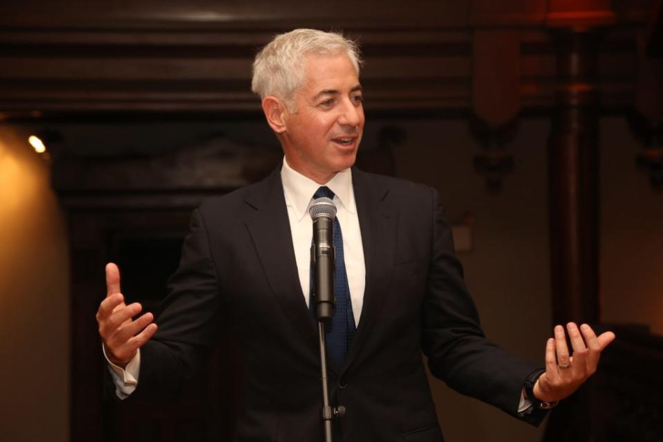 Bill Ackman is seen in formal attire at a microphone mid-speech.