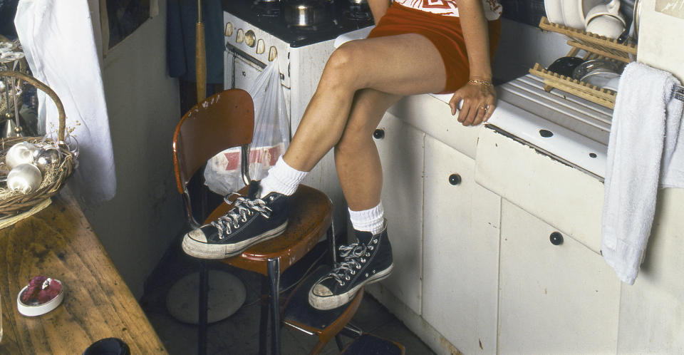 A person sitting on the kitchen counter