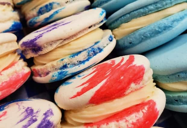 Mother’s Cupboard makes a variety of macarons, like these cotton candy macarons with buttercream filling and vanilla galaxy macarons with chocolate ganache inside. (Submitted by Andrew and Kayla Bowen - image credit)