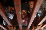 <p>Indian fishermen stand behind bars after being arrested by the Pakistani authorities, in Karachi, Pakistan, May 4, 2017. (Photo: Shahzaib Akber/EPA) </p>