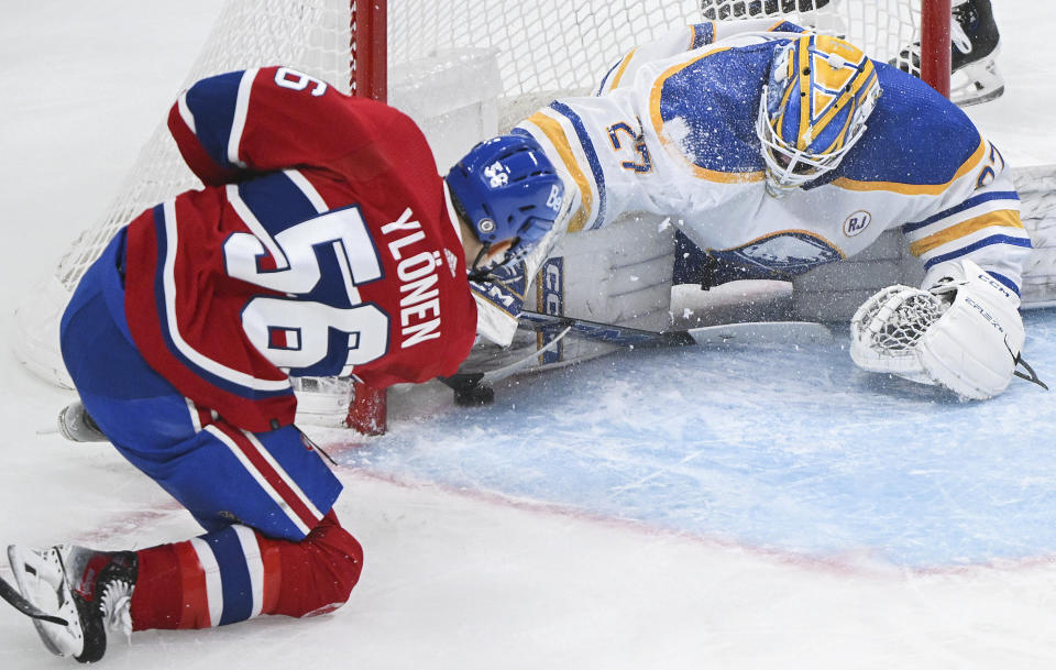 Montreal Canadiens' Jesse Ylonen tries to jam the puck by Buffalo Sabres goaltender Devon Levi during the first period of an NHL hockey game Thursday, Jan. 4, 2024, in Montreal. (Graham Hughes/The Canadian Press via AP)