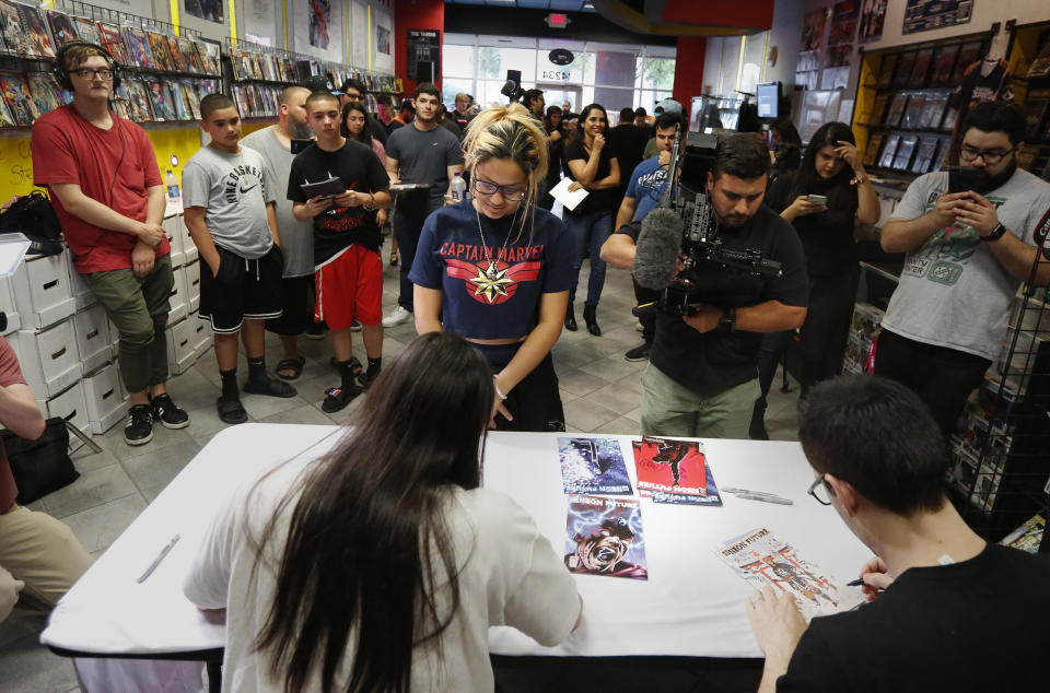 A large group of fans gather to get autographs from Steve Aoki during a comic book signing of his new "Neon Future" comic book series at Multiverse Corps. Comics on Thursday, May 2, 2019, in Miami. (AP Photo/Brynn Anderson)