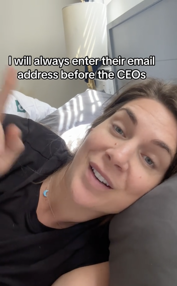 Woman in bed gestures while text on screen reads about entering an email address before CEOs'