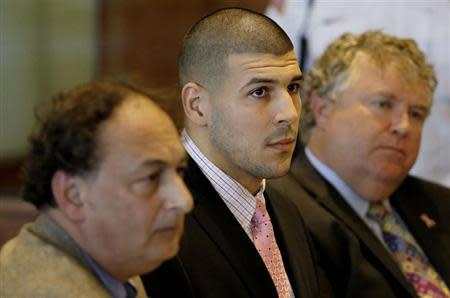 Former New England Patriots NFL football playerAaron Hernandez, (C), sits with his attorneys James Sultan (L) and Michael Fee in Bristol Superior Court in Fall River, Massachusetts, October 21, 2013. REUTERS/Stephan Savoia/ Pool