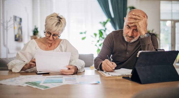 A senior couple calculating their cost of living for retirement.