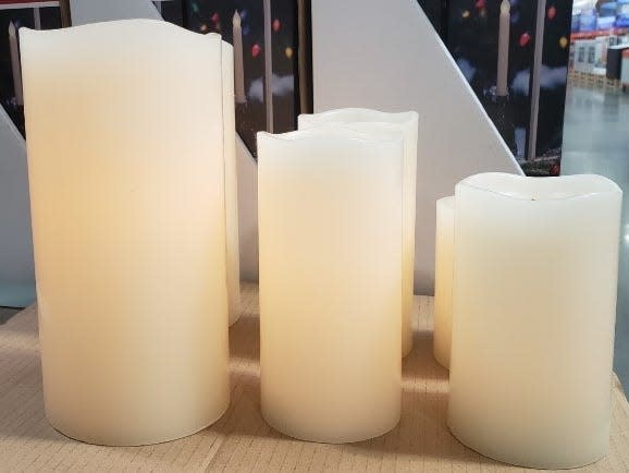 LED light up white candles of different heights on box at Costco