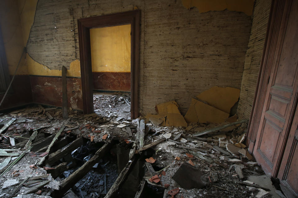 This Saturday, July 21, 2018 photo, shows a view of damaged rooms inside the Prinkipo orphanage, a 6-floor timber building that once served as an orphanage for children of the minority Greek community, in Buyukada, the largest and most popular of the Princes' Islands in the Sea of Marmara near Istanbul. The 120-year-old gigantic building, occupying 20,000 square meters on a hilltop_ became home for some 5,800 minority Greek children from 1903 until 1964 when it was forced to shut down. (AP Photo/Lefteris Pitarakis)