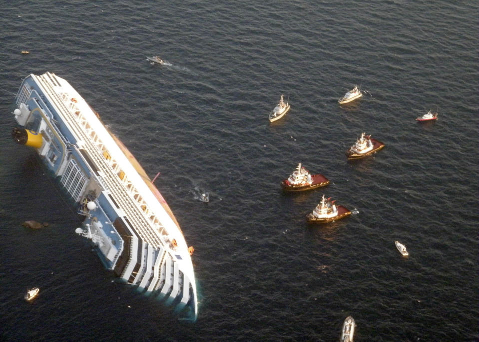 FILE - In this Saturday, Jan. 14, 2012 file photo released by the Guardia di Finanza (border Police), the luxury cruise ship Costa Concordia leans on its side after running aground the tiny Tuscan island of Giglio, Italy. As if the nightmares, flashbacks and anxiety weren't enough, passengers who survived the terrifying grounding and capsizing of the Costa Concordia off Tuscany have come in for a rude shock as they mark the first anniversary of the disaster on Sunday, Jan. 13, 2013. Ship owner Costa Crociere SpA, the Italian unit of Miami-based Carnival Corp., sent several passengers a letter telling them they weren't welcome at the official anniversary ceremonies on the island of Giglio where the hulking ship still rests. Costa says the day is focused on the families of the 32 people who died Jan. 13, 2012, not the 4,200 passengers and crew who survived. (AP Photo/Guardia di Finanza,File)