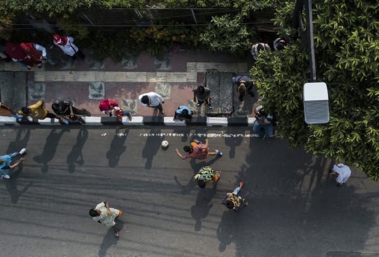 Workers played football, held tugs-of-war and climbed a greasy bamboo pole as part of their traditional celebrations