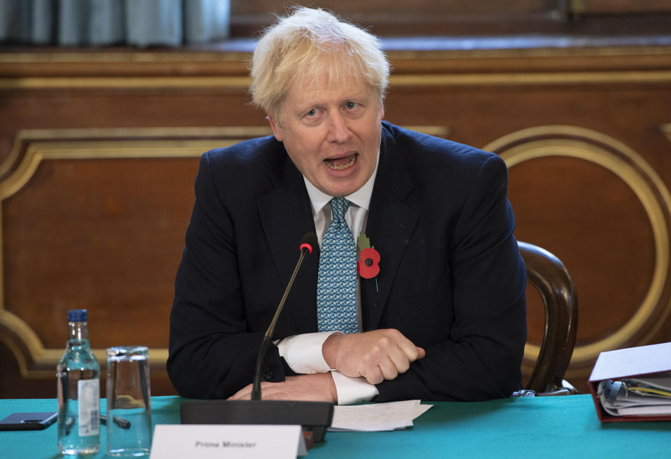 Britain's Prime Minister Boris Johnson, leads a Cabinet meeting, at the Foreign and Commonwealth Office (FCO), in London, Tuesday, Nov. 3, 2020. (Eddie Mulholland, Pool Photo via AP)