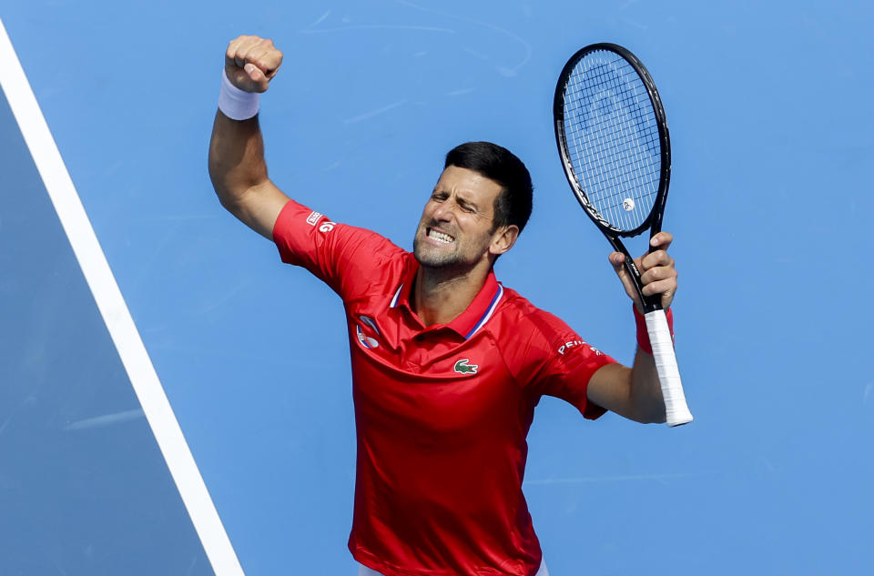 Serbia's Novak Djokovic celebrates after defeating Canada's Denis Shapovalov in their ATP Cup match in Melbourne, Australia, Tuesday, Feb. 2, 2021. (AP Photo/Hamish Blair)