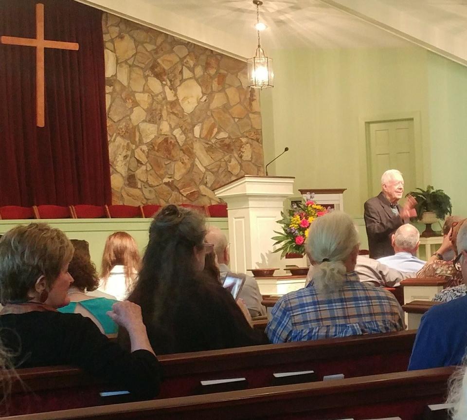 Former president Jimmy Carter (far right) greets visitors at a 2017 Sunday school lesson at Maranatha Baptist Church in Plains, Ga.