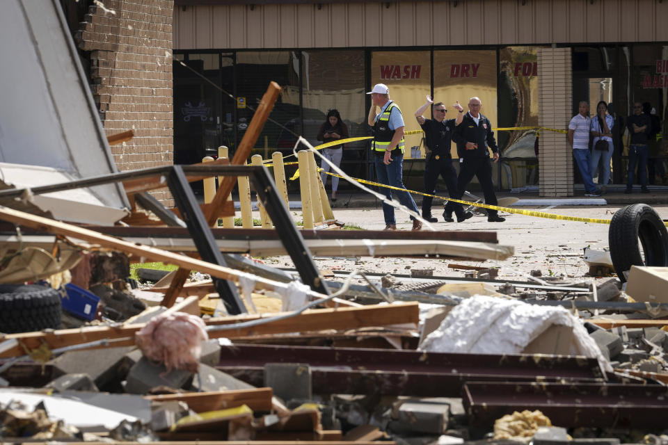 Authorities work at the scene where a tornado damaged several businesses Wednesday, April 10, 2024, in Katy, Texas. (Jon Shapley/Houston Chronicle via AP)