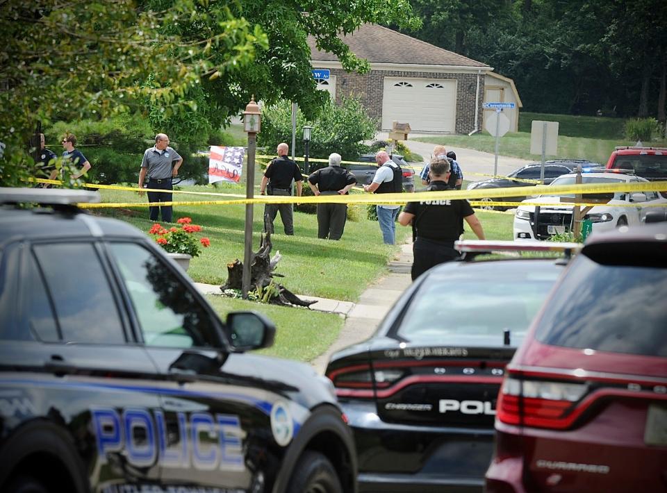 Police investigate a shooting Friday, Aug. 5, 2022, in Butler Township, Ohio.  Authorities say four people were shot to death in the Ohio suburb and a man considered armed and dangerous is being sought.