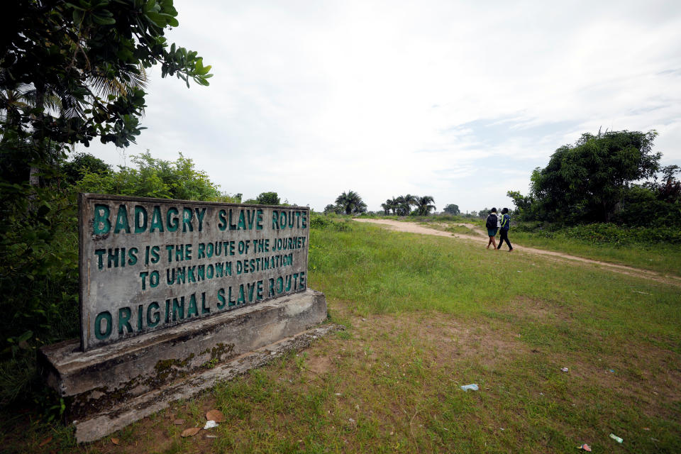 Two people walk along the route taken by slaves to the "point of no return" , from where they were shipped west, at the historic slave port of Badagry, Nigeria. (Photo: Afolabi Sotunde/Reuters)