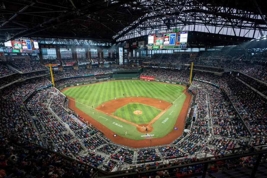 Fans watch an opening day baseball game at Globe Life Field in Arlington, Texas. (AP Photo/Jeffrey McWhorter)