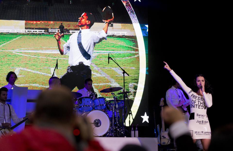 Singer Katy Perry performs for a crowd before the arrival of President Barack Obama at a campaign rally, Wednesday, Oct. 24, 2012, in Las Vegas. (AP Photo/Julie Jacobson)