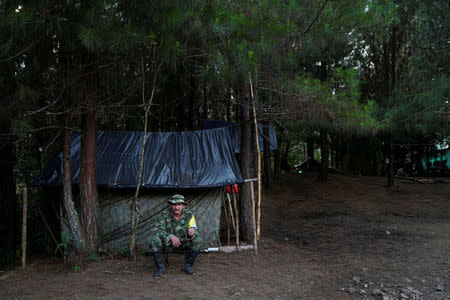 Juancho smokes a cigarette outside his makeshift tent in Los Robles, Colombia, January 25, 2017. REUTERS/Federico Rios