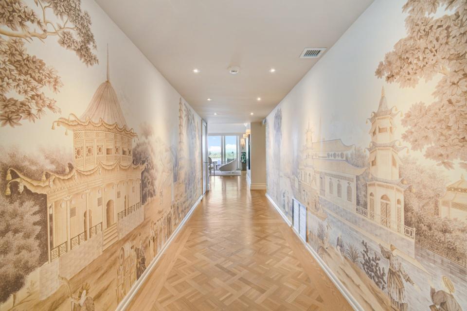 A dramatic wallcovering with an Asian theme adds visual interest to the gallery hall. Note the parquet floor in the same tones.