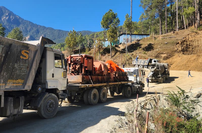 A new auger machine arrives at the site where road workers are trapped in a tunnel after a portion of it collapsed, in Uttarkashi