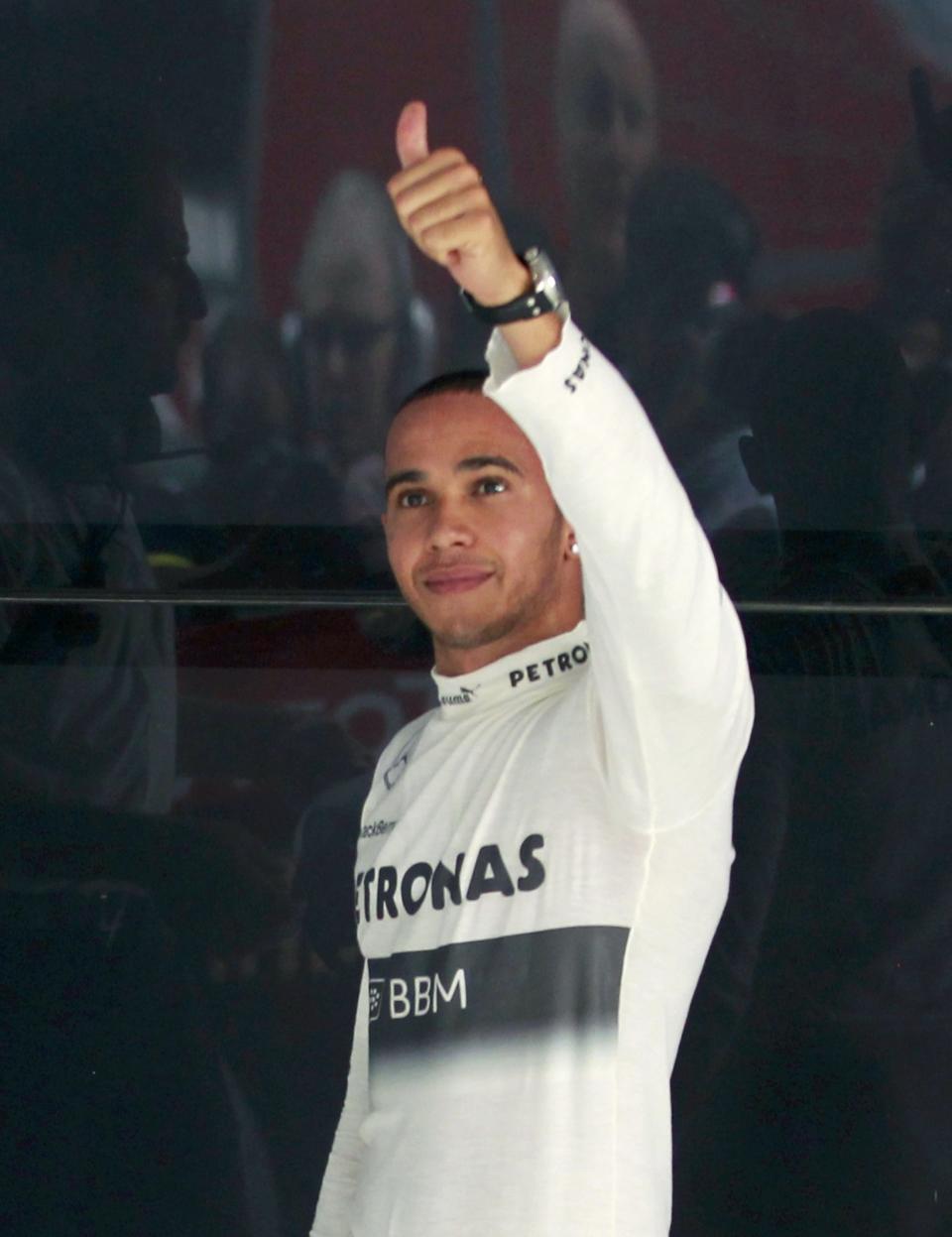 Mercedes Formula One driver Lewis Hamilton of Britain gives a thumbs up after the qualifying session of the Indian F1 Grand Prix at the Buddh International Circuit in Greater Noida, on the outskirts of New Delhi, October 26, 2013. REUTERS/Anindito Mukherjee (INDIA - Tags: SPORT MOTORSPORT F1)