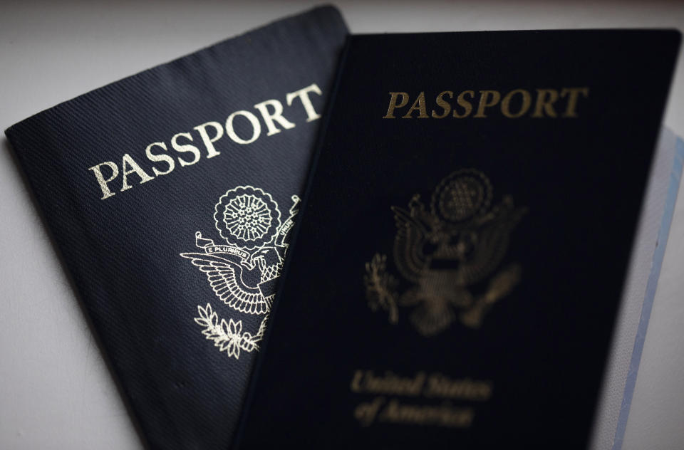 FILE - The cover of a U.S. Passport is displayed in Tigard, Ore., Dec. 11, 2021. Seeking a valid U.S. passport for that 2023 trip? Buckle up, wishful traveler, for a very different journey before you step anywhere near an airport. A much-feared backup of U.S passport applications has smashed into a wall of government bureaucracy as worldwide travel rebounds toward record pre-pandemic levels — with too few humans to handle the load. (AP Photo/Jenny Kane, File)