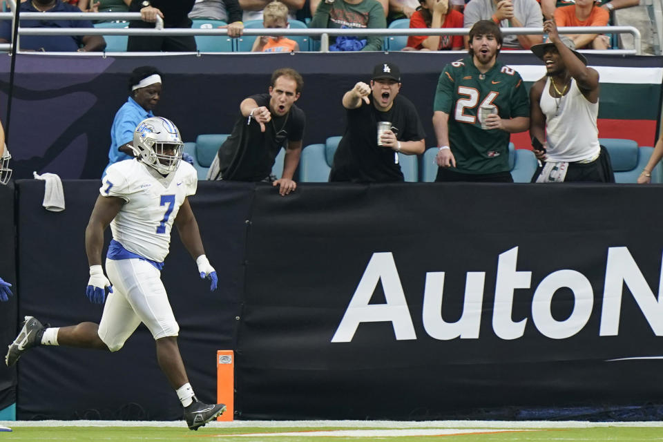 Middle Tennessee defensive tackle Zaylin Wood (7) celebrates after intercepting and scoring during the first half of an NCAA college football game against Miami, Saturday, Sept. 24, 2022, in Miami Gardens, Fla. (AP Photo/Wilfredo Lee)