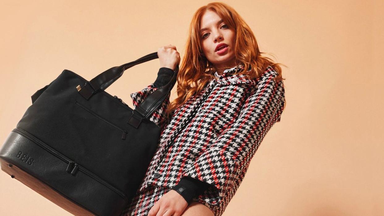 a woman holding a black briefcase