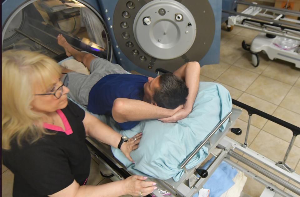 Veteran Tim Hammer gets removed from the hyperbaric chamber by nurse Laura Mastrony on Friday, May 20, 2022 in Delray Beach.