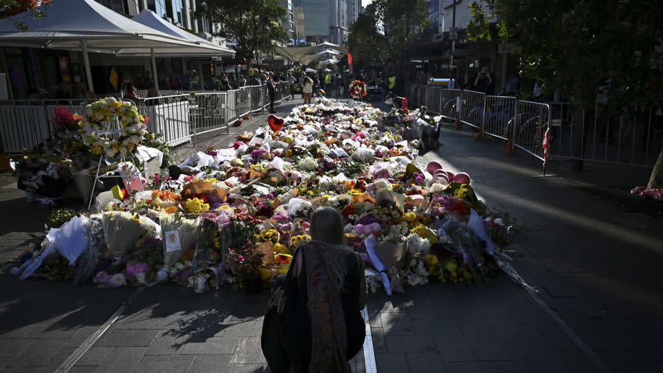 People leave floral tributes for victims of the attack at Westfield Bondi Junction shopping center in Sydney on April 16, 2024. - Steven Saphore/AAP/Reuters